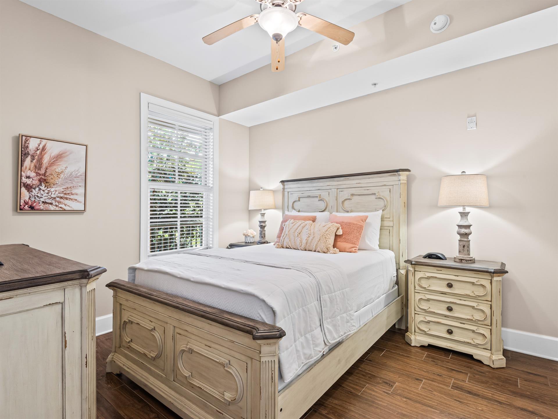 Bedroom 4 Drift off to peaceful sleep in your elegant bedroom featuring soft coral accents beneath the gentle breeze of your ceiling fan.