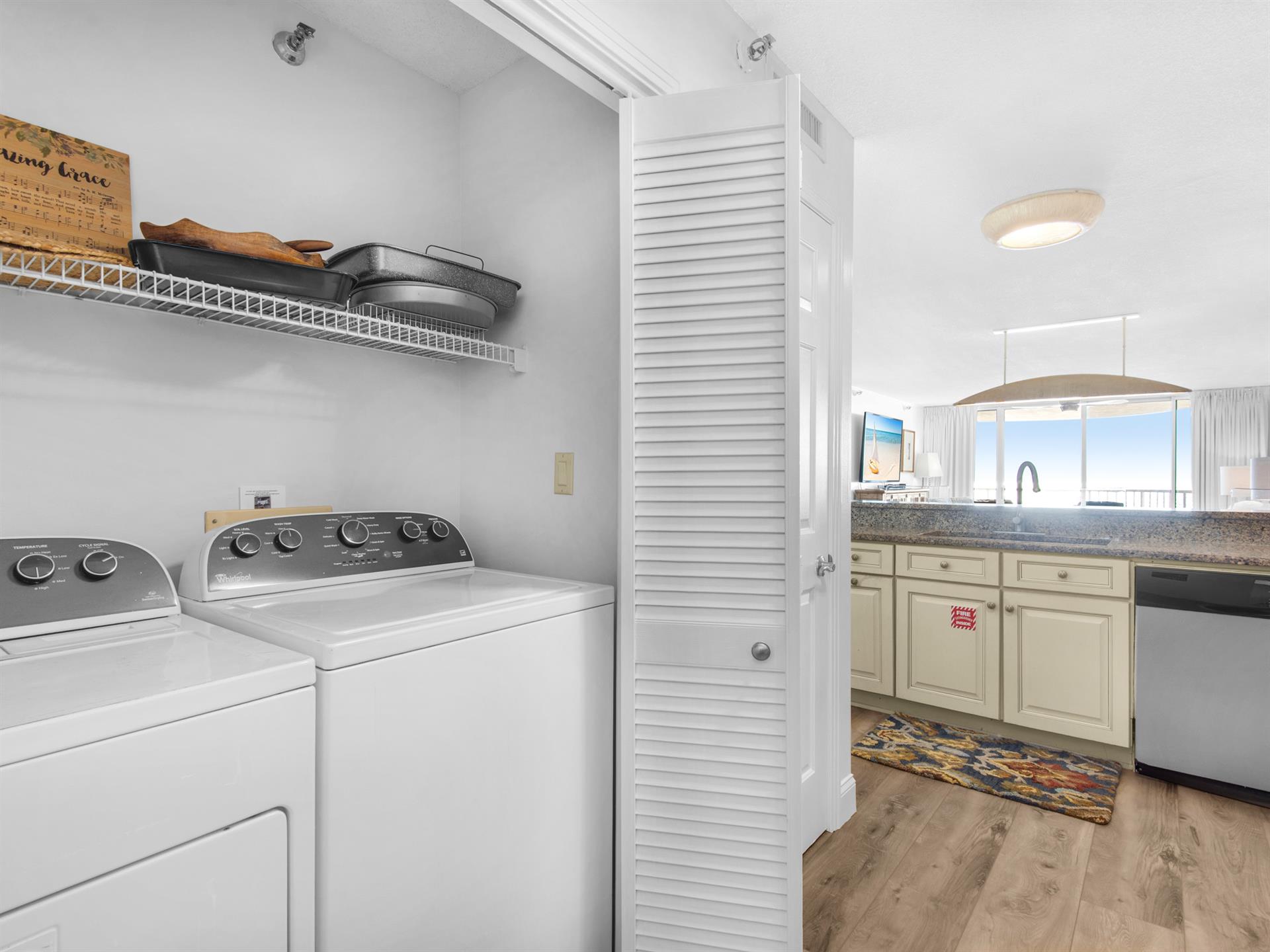 Your laundry area features fullsize washer and dryer with handy shelving, seamlessly connected to your wellequipped kitchen for effortless convenience.