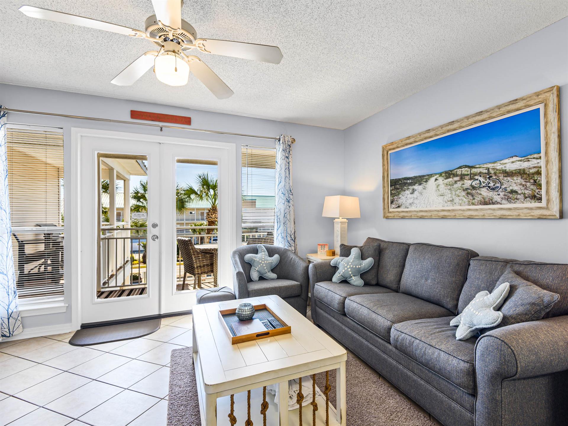 Sink into this cozy living room where beach breezes flow through French doors to the private balcony.
