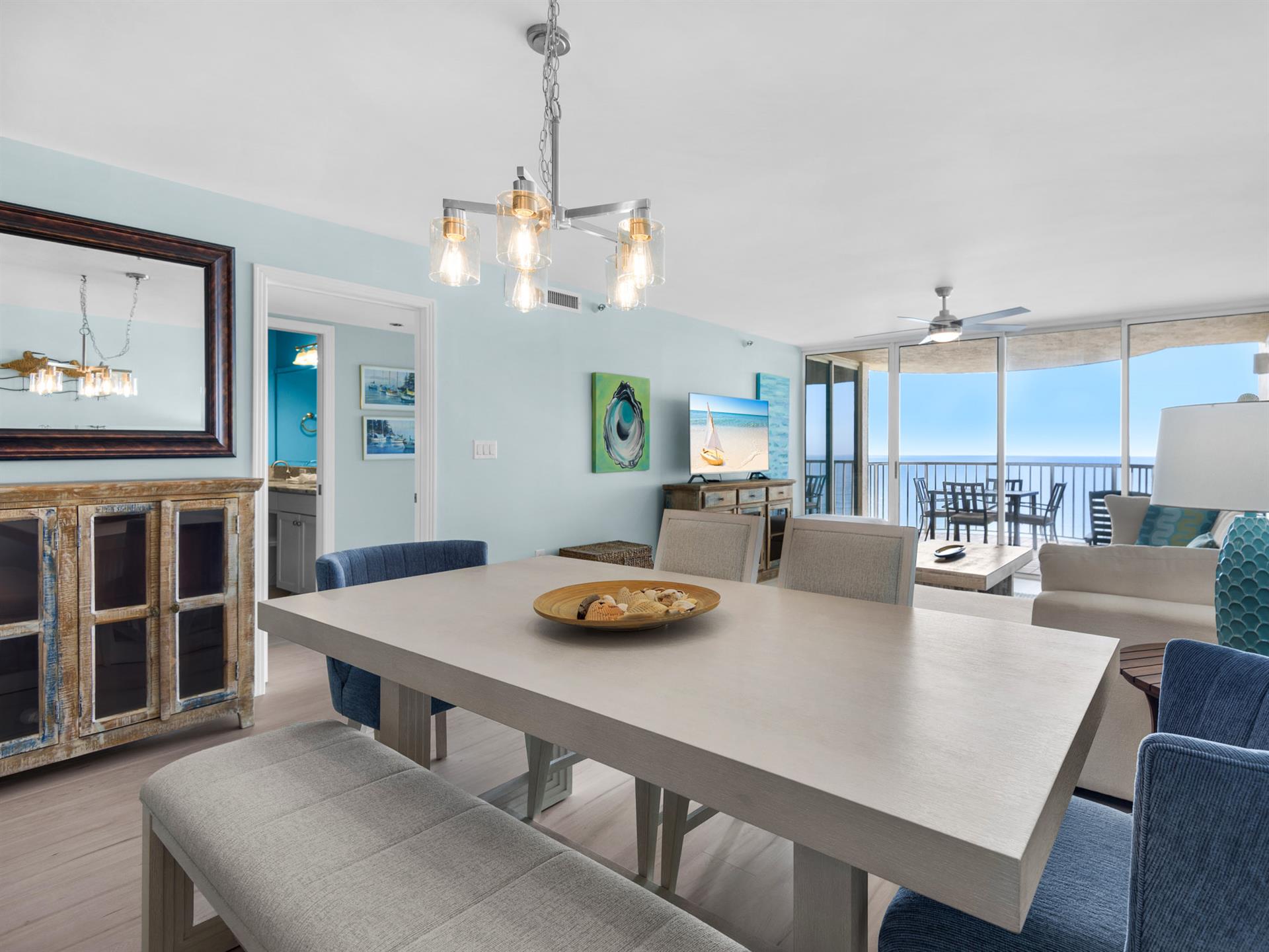 Gather around your spacious dining table for memorable meals with ocean breezes flowing through floortoceiling windows and endless sea views as your backdrop.