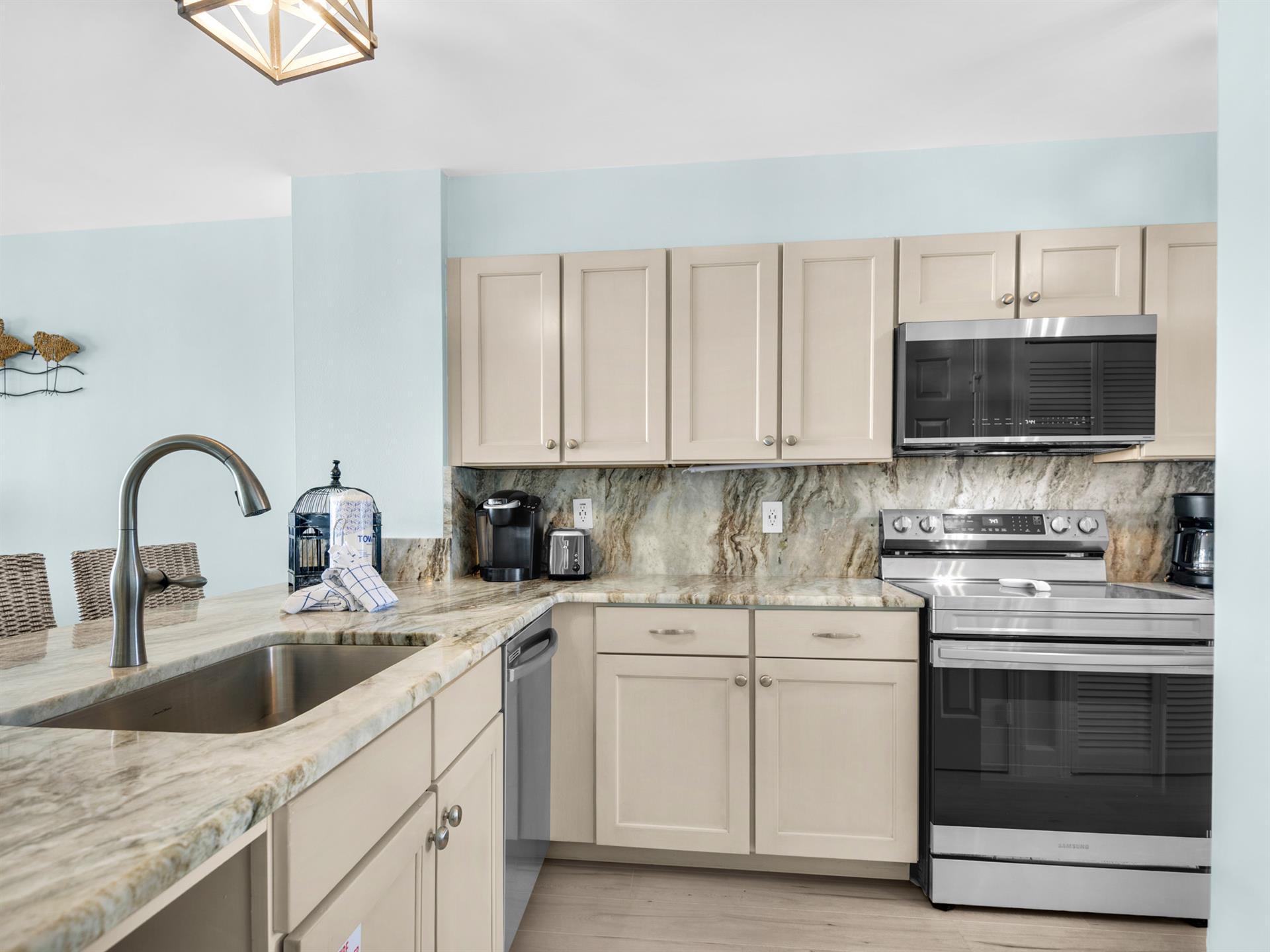 Your fully equipped kitchen awaits with granite countertops, stainless appliances, and everything needed for homecooked meals during your stay.