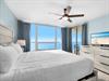 Wake up to endless ocean views from your serene bedroom, where soft blue walls and crisp linens create your perfect coastal retreat.