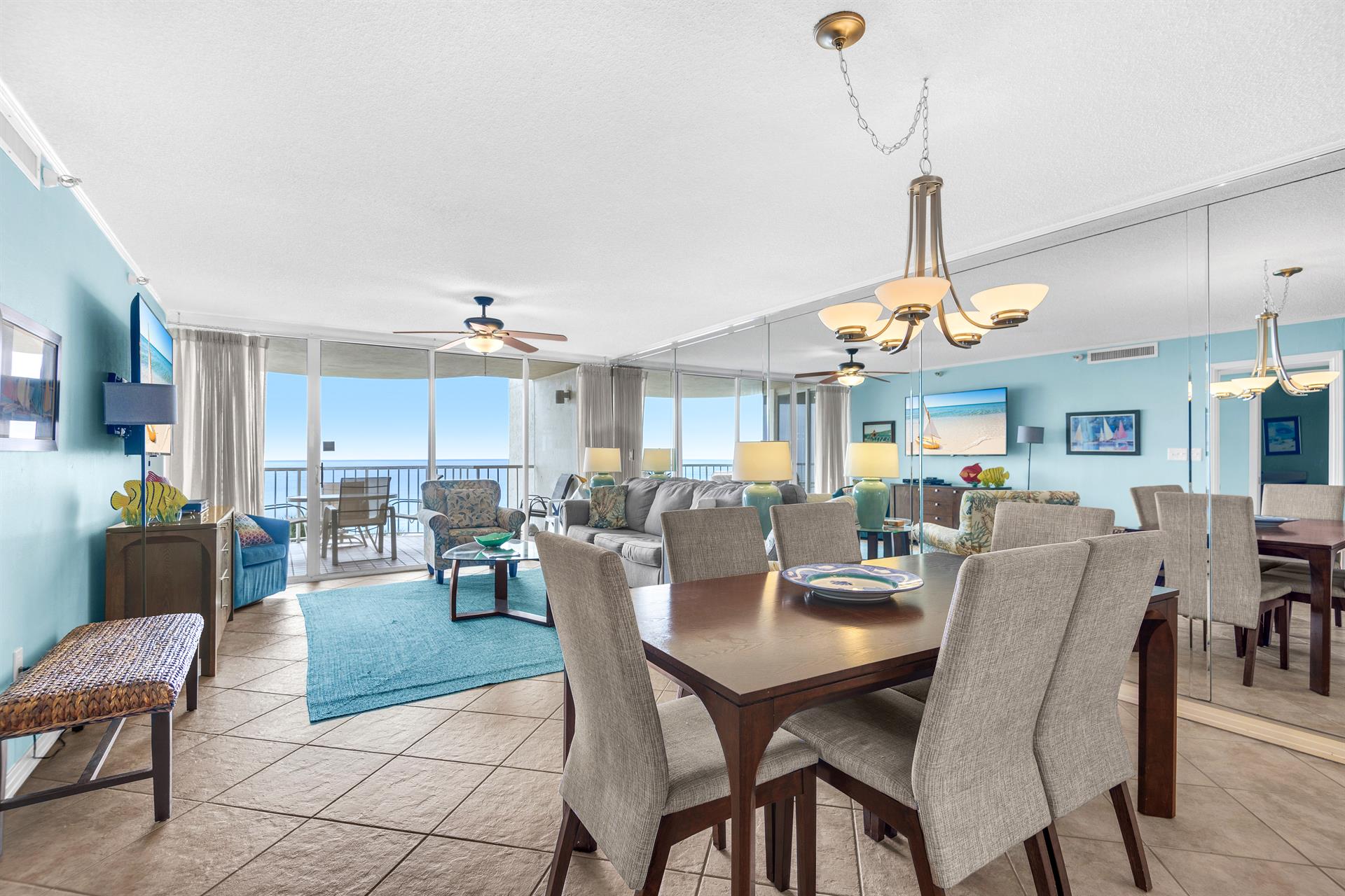 Relax in your spacious oceanfront living area with panoramic sea views, comfortable seating, and elegant dining space perfect for memorable meals.