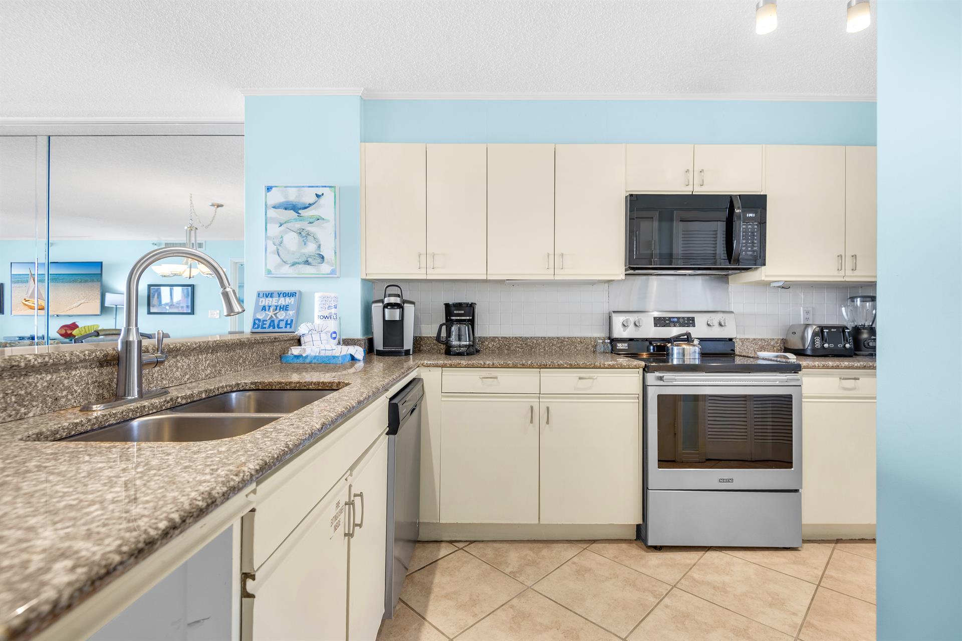 Your fully equipped kitchen features granite countertops, stainless steel appliances, and a stunning ocean view to inspire every meal.