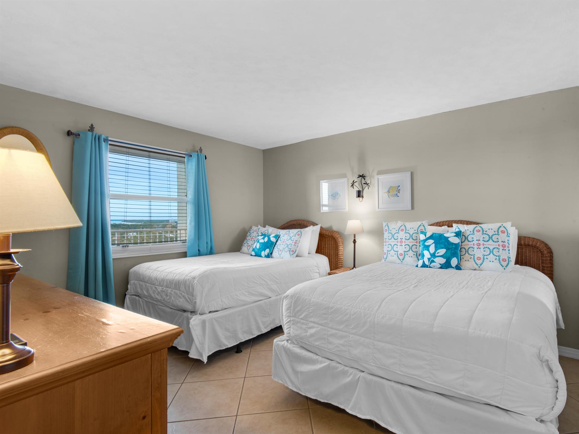 Rest easy in your double bedroom with crisp linens, cheerful turquoise accents, and a peaceful view to start each morning refreshed.