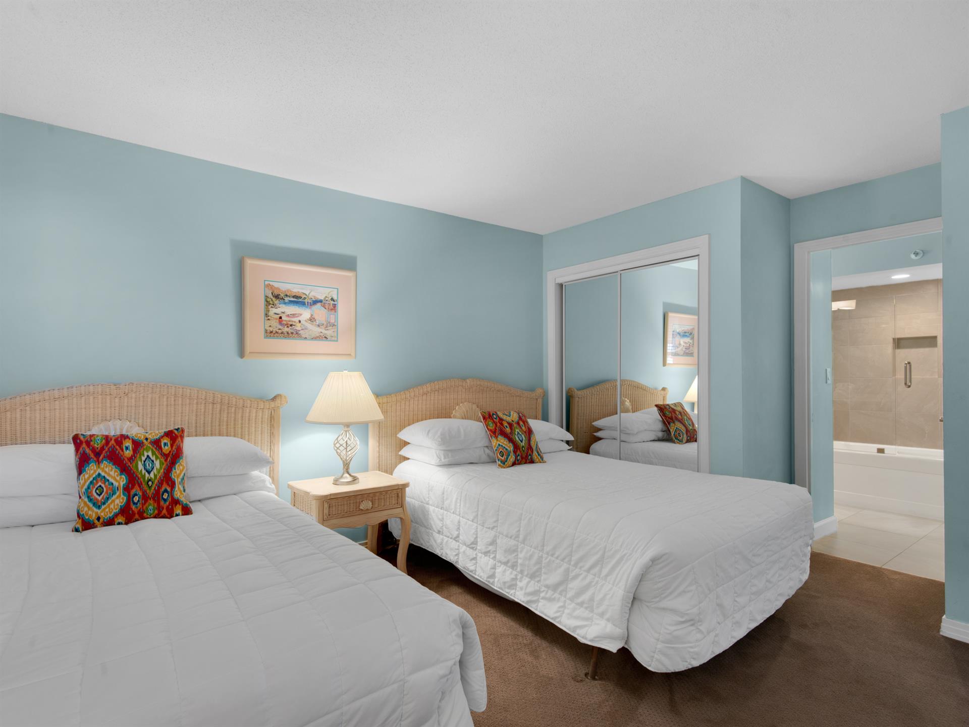 Rest peacefully in your double beds with soft linens and colorful accents, surrounded by soothing coastal blue walls.