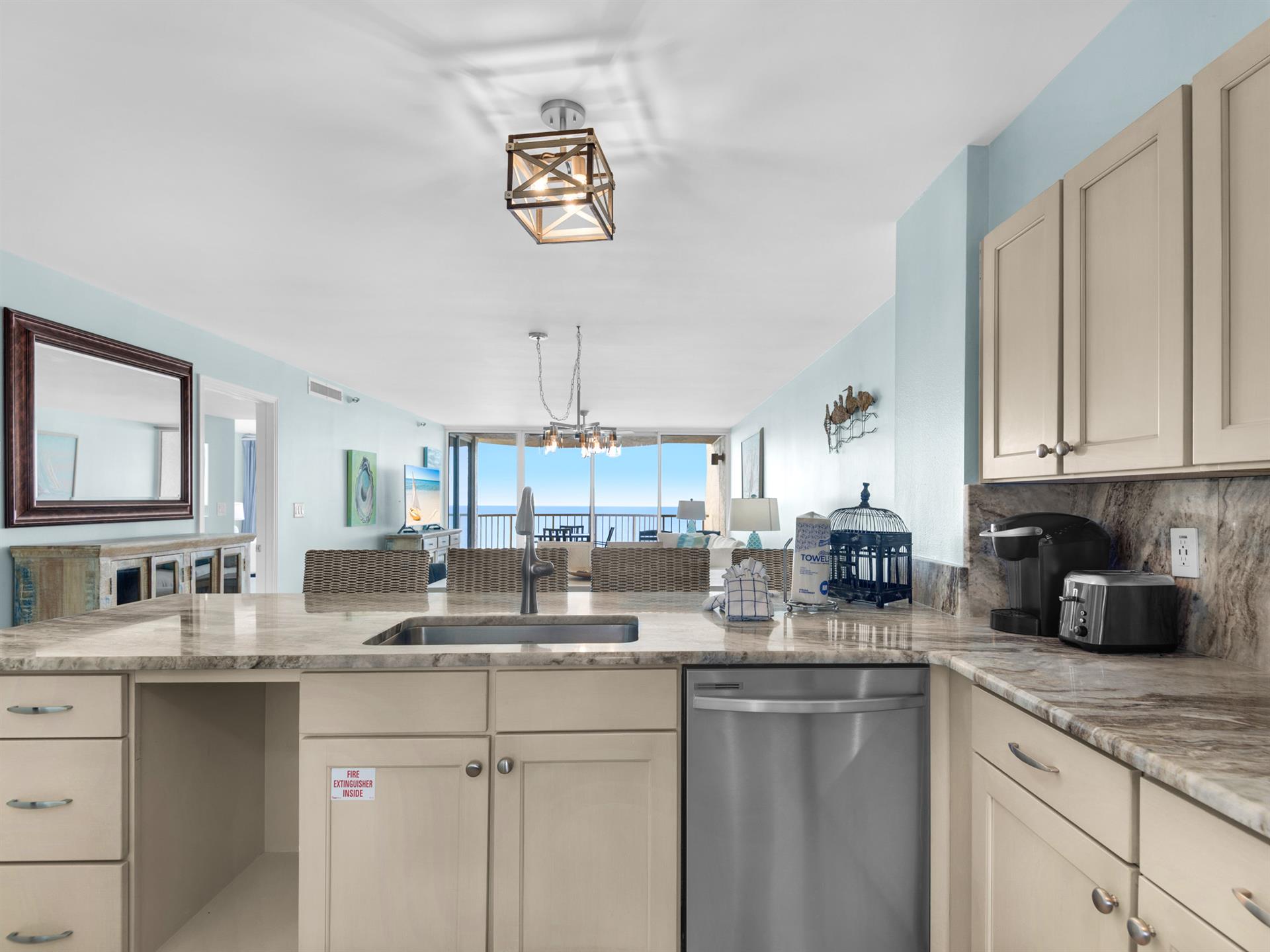 Your fully equipped kitchen opens to stunning ocean views, making meal prep a pleasure with granite counters and stainless appliances.
