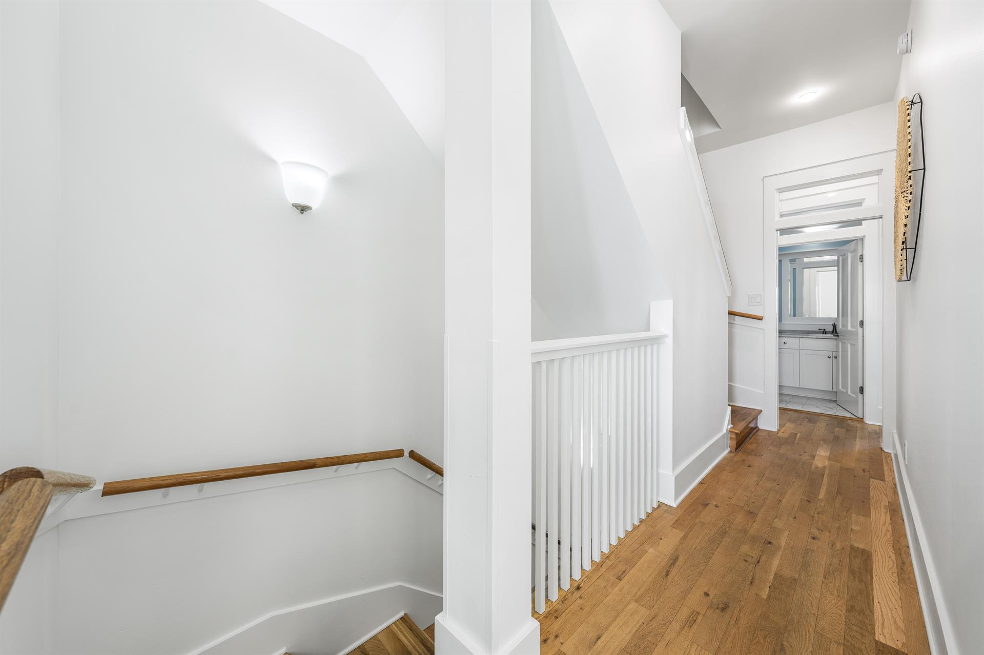 Hallway Between the two bedrooms on the Third Floor and Stairs Leading the the Second Floor Living and Dining Area.