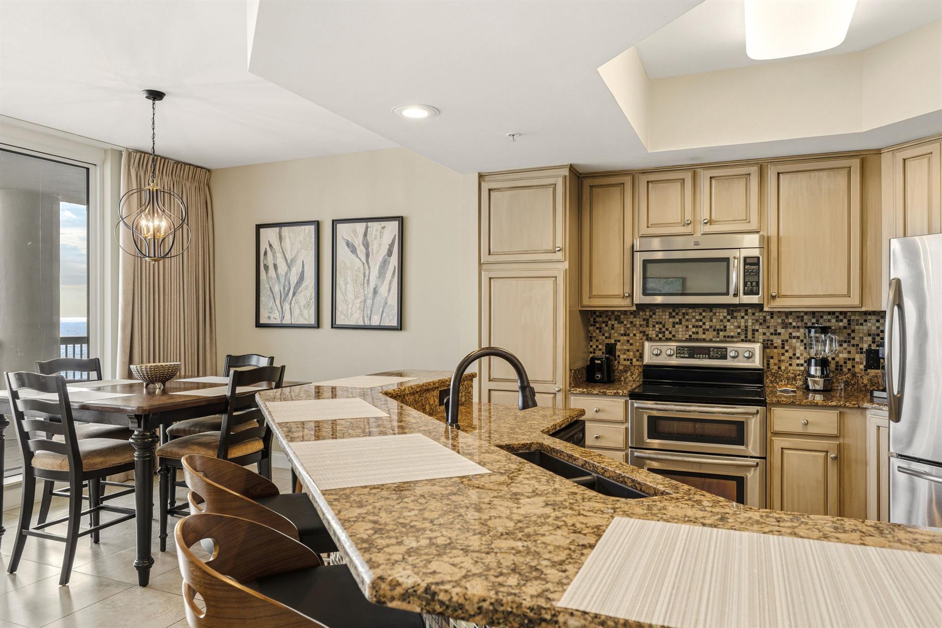 Your fully equipped kitchen with granite counters and stainless appliances flows into a dining area perfect for memorable meals together.