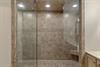 Bathroom1 features spalike shower sanctuary with luxurious stone tiles and elegant glass enclosure.