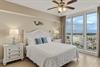 Bedroom 2 features crisp white linens and turquoise accents offering sweeping city views for peaceful mornings.