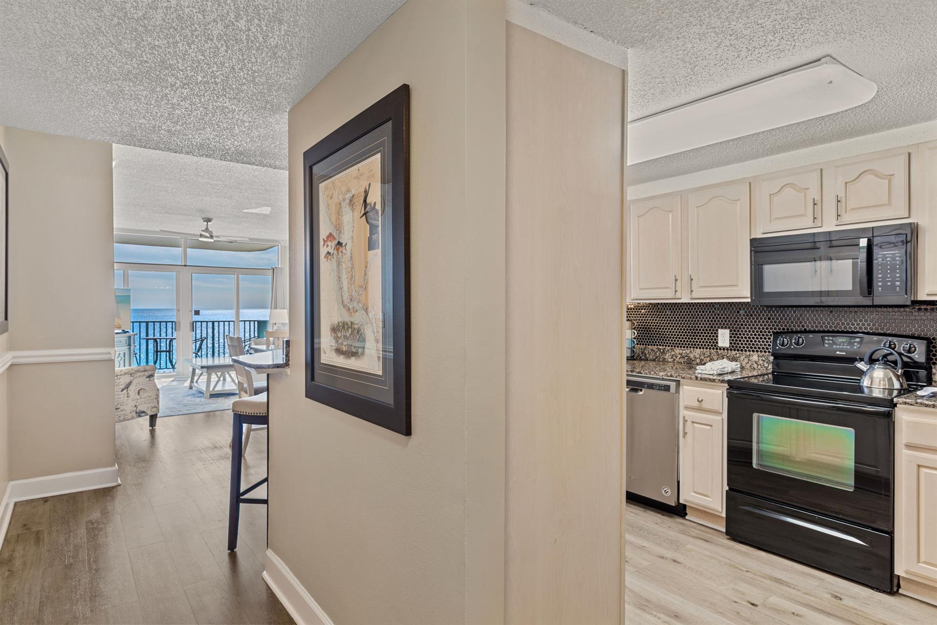 Fully equipped kitchen with ocean views stretching to your dining area, creating the perfect backdrop for vacation meals.