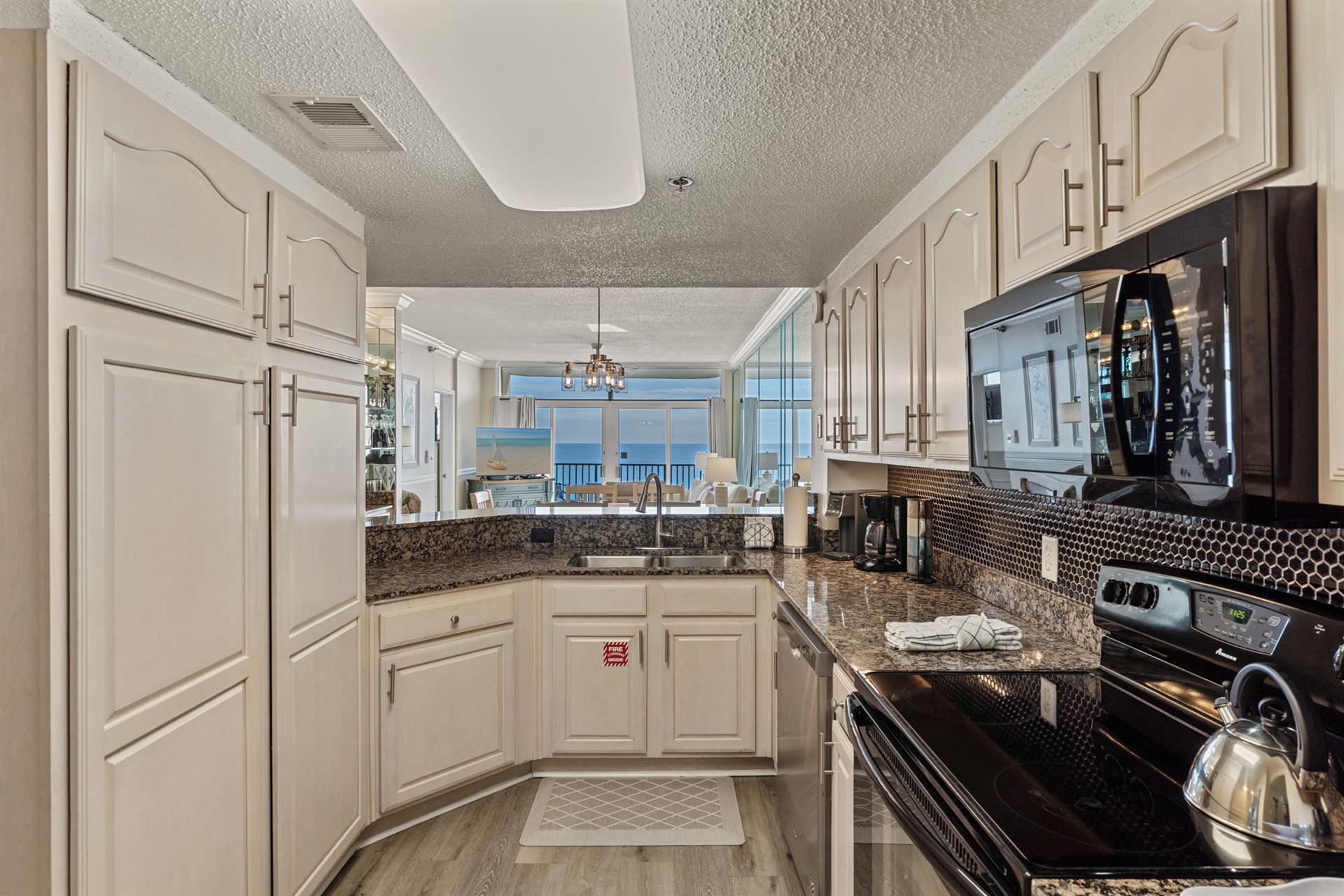 Your fully equipped kitchen features granite countertops and stunning ocean views, perfect for preparing meals while enjoying the scenery.