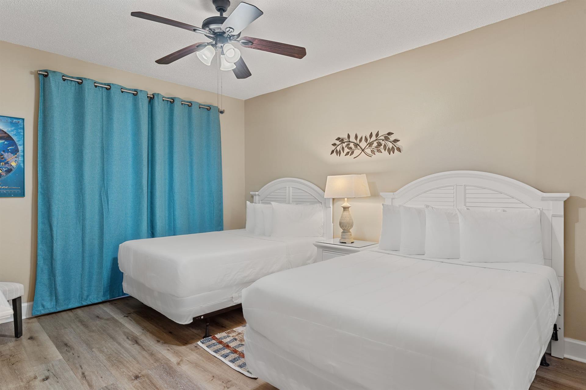 Bedroom 2 your double bed retreat with coastal vibes and cooling comfort from your ceiling fan overhead.