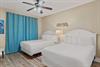 Bedroom 2 your double bed retreat with coastal vibes and cooling comfort from your ceiling fan overhead.