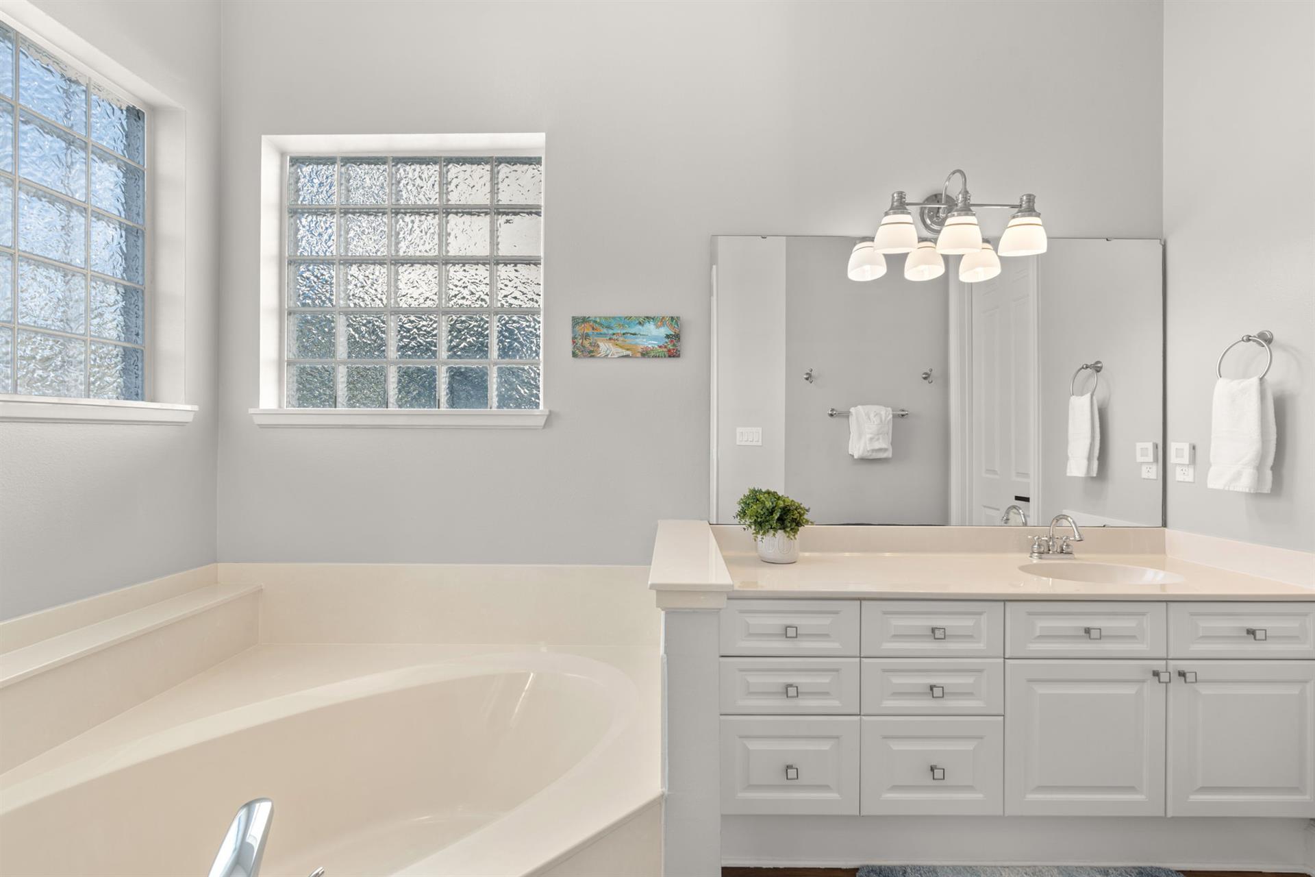 Bathroom 1 with Double Vanities and Natural Lighting