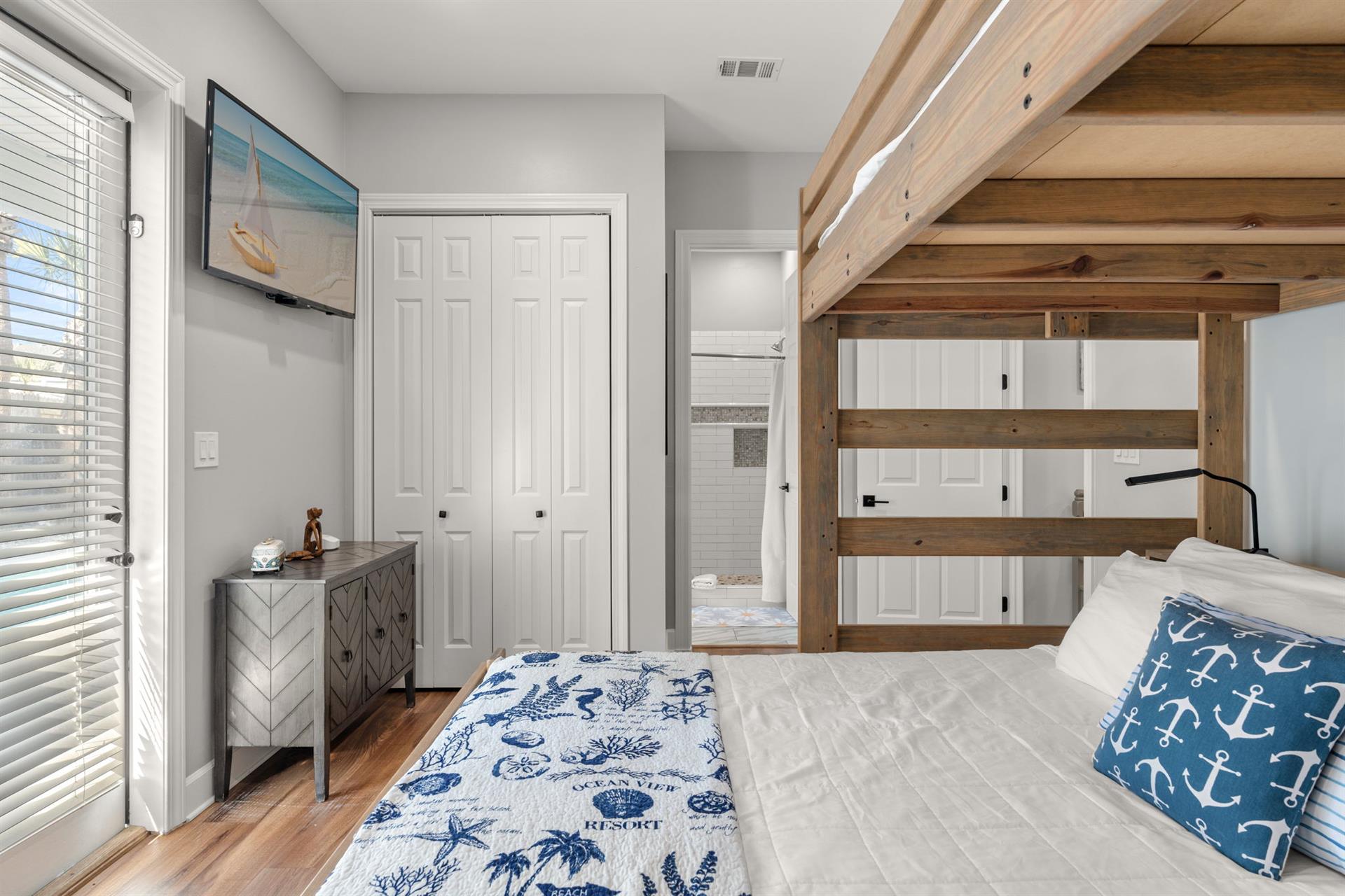 The nauticalthemed bedroom features a cozy bunk bed with custom wood beams, perfect for families or groups sharing adventure.