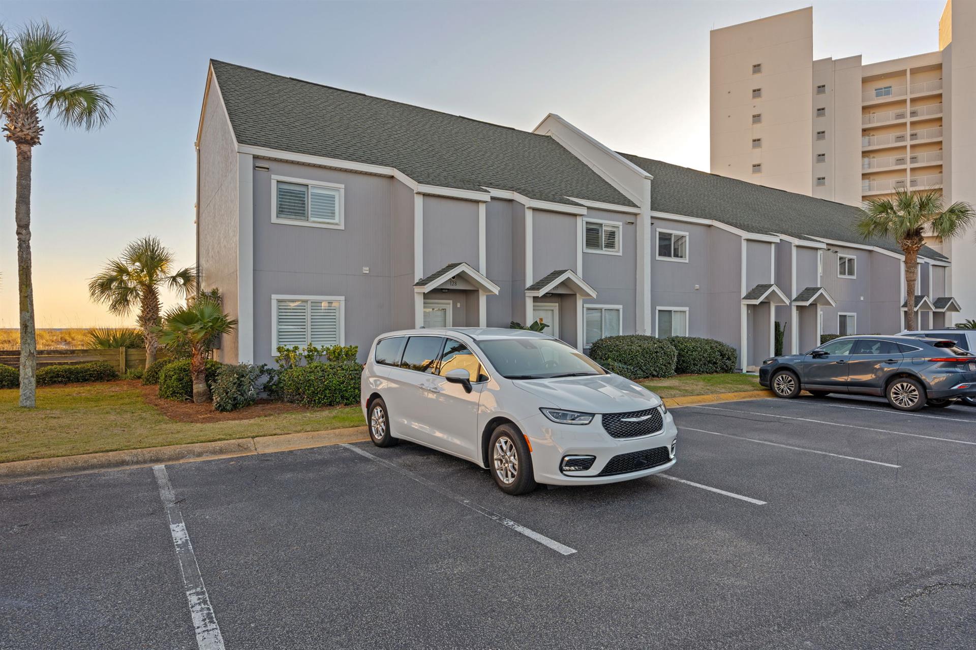 Multiunit vacation townhomes with convenient parking, nestled among palm trees in a peaceful coastal setting.