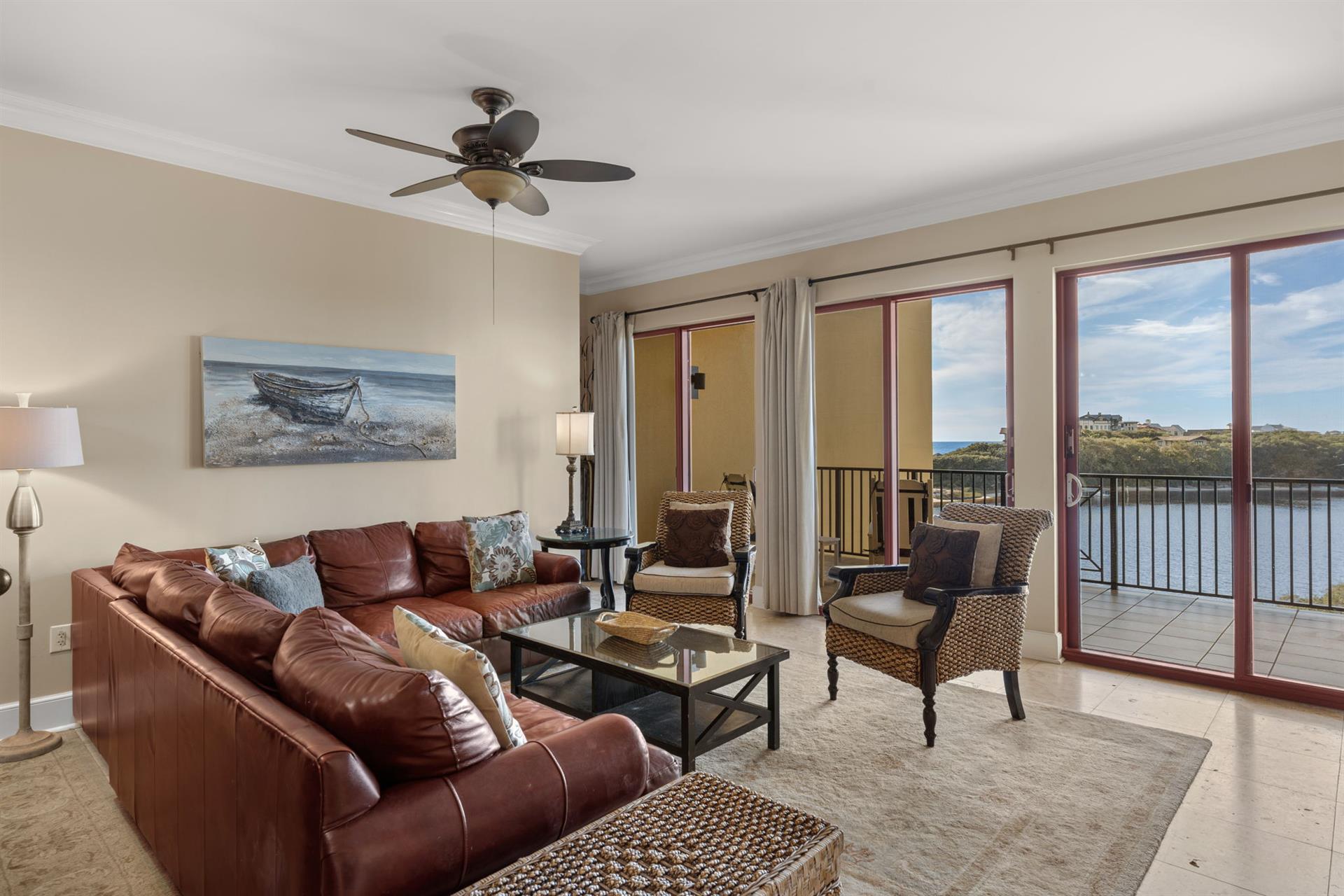 Unwind in your gulf and lakefront living room where rich leather furnishings and panoramic water views create the perfect backdrop for relaxation.