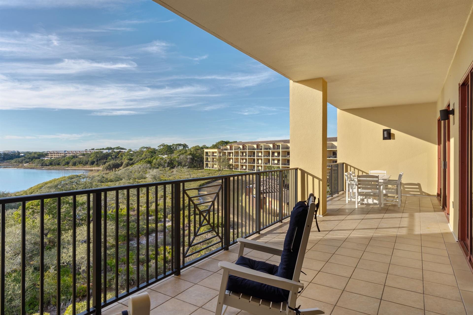 Unwind on your first floor private gulf and lakefront balcony with stunning water views and comfortable seating for peaceful morning coffee or evening relaxation.