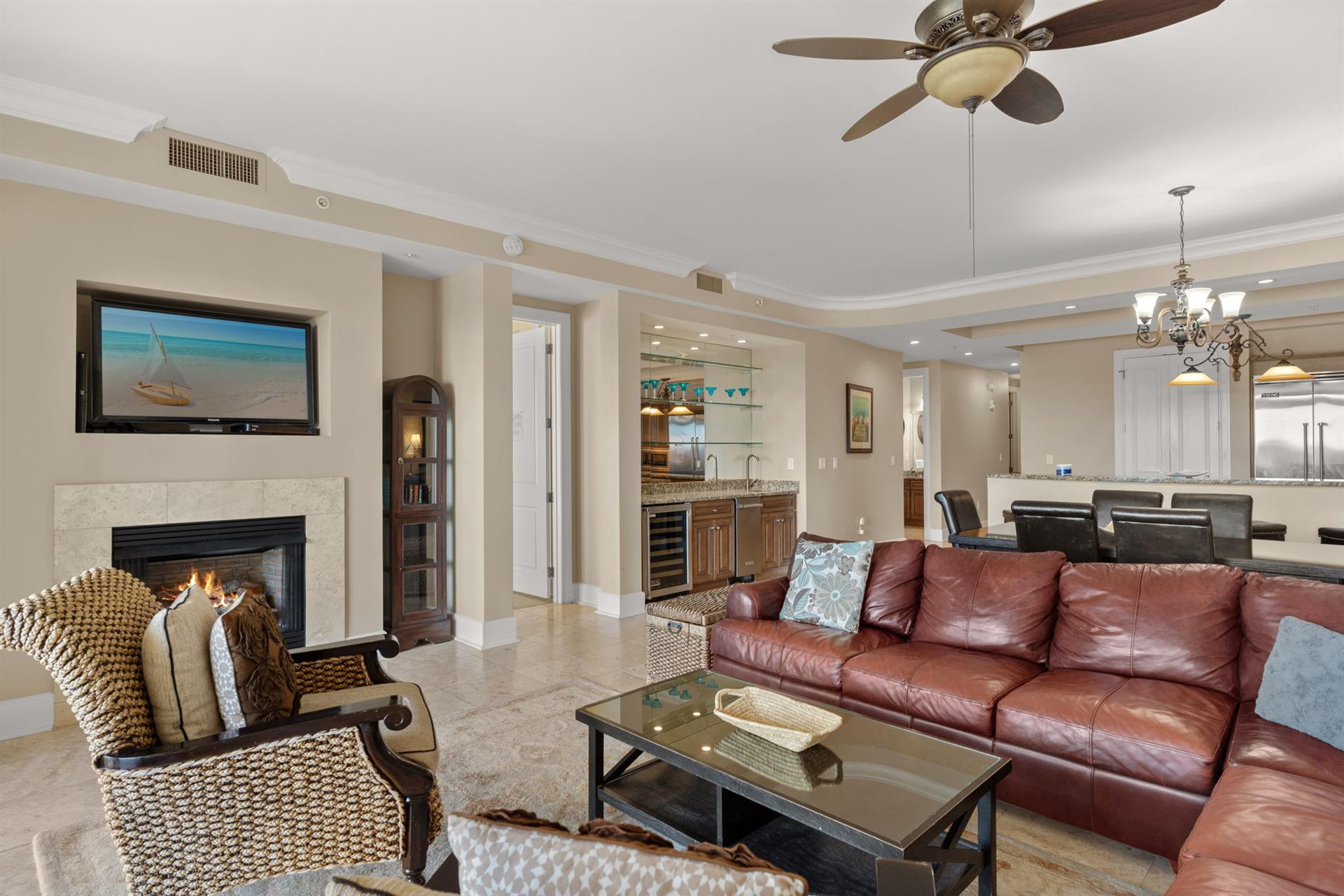 Sink into buttery leather sofas while the fireplace warms your evening conversations in this elegantly appointed living space.