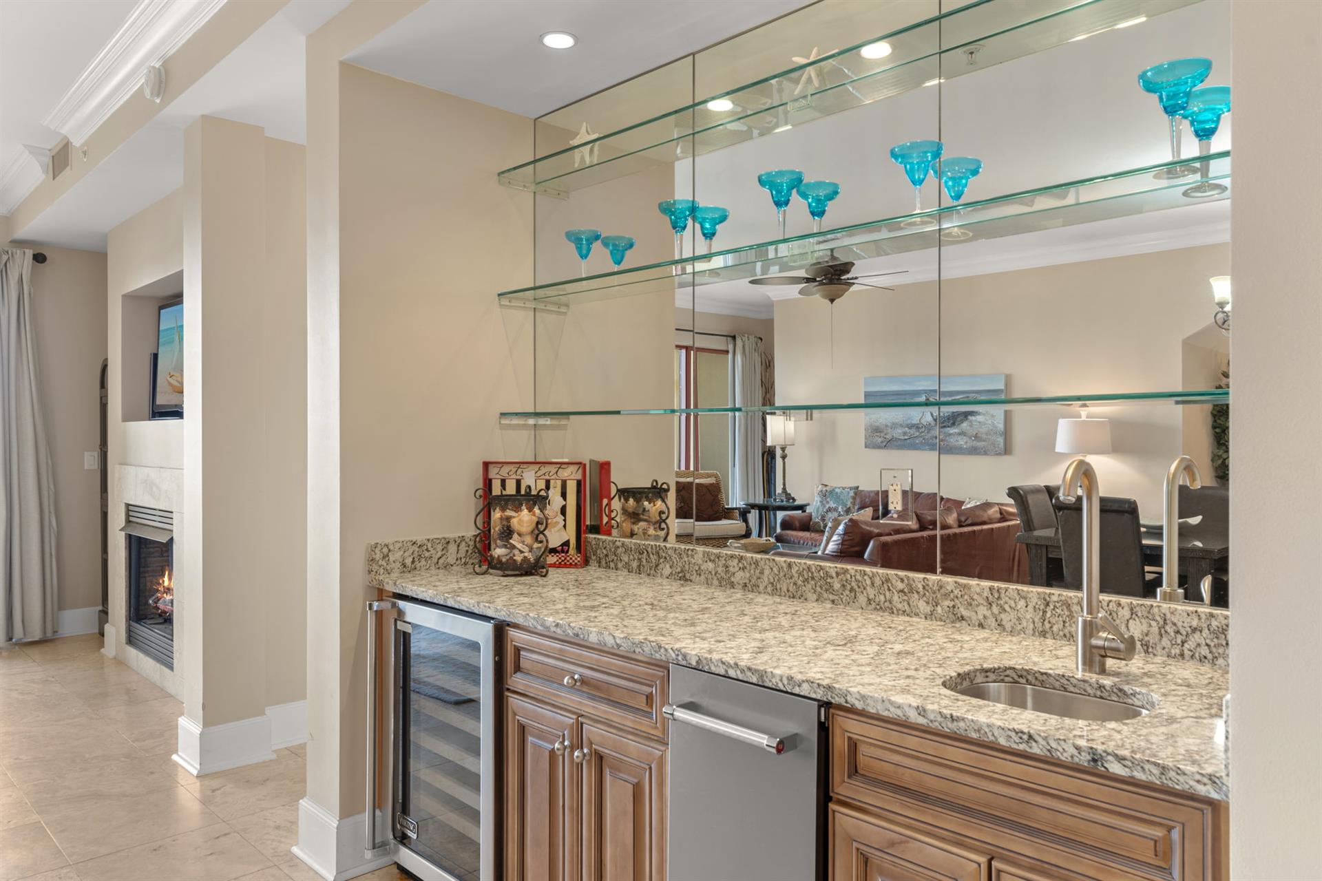 Your elegant private bar features granite countertops, stylish glass shelving, wine chiller and ice maker for effortless entertaining.