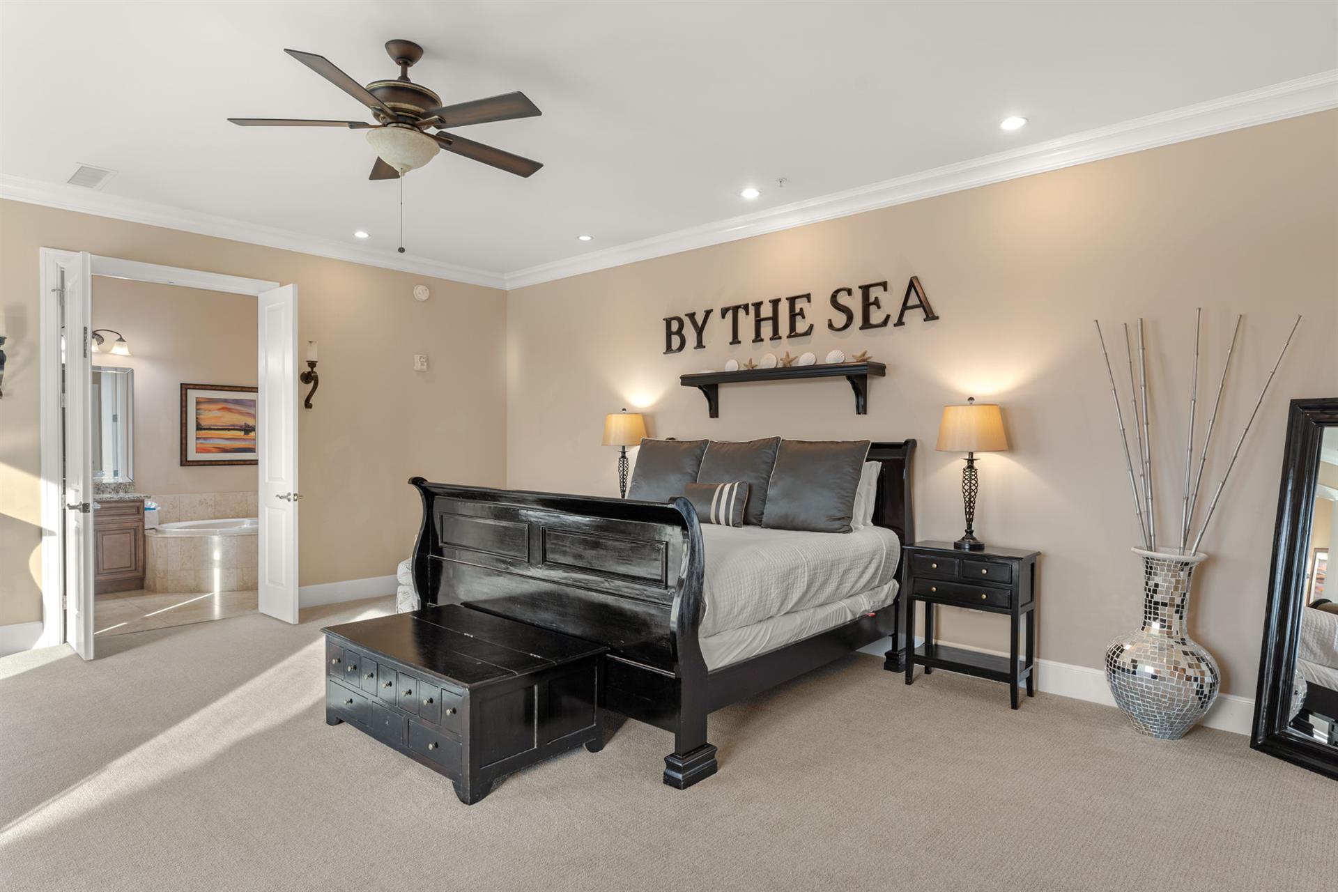 Your coastal retreat awaits with a plush king bed, gentle ceiling fan, and nautical touches that whisper seaside dreams.