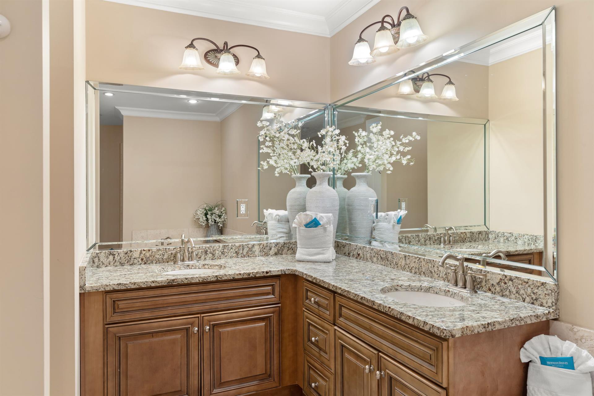 Step into your elegant bathroom with granite countertops, designer lighting, and thoughtful amenities that make your morning routine feel luxurious.