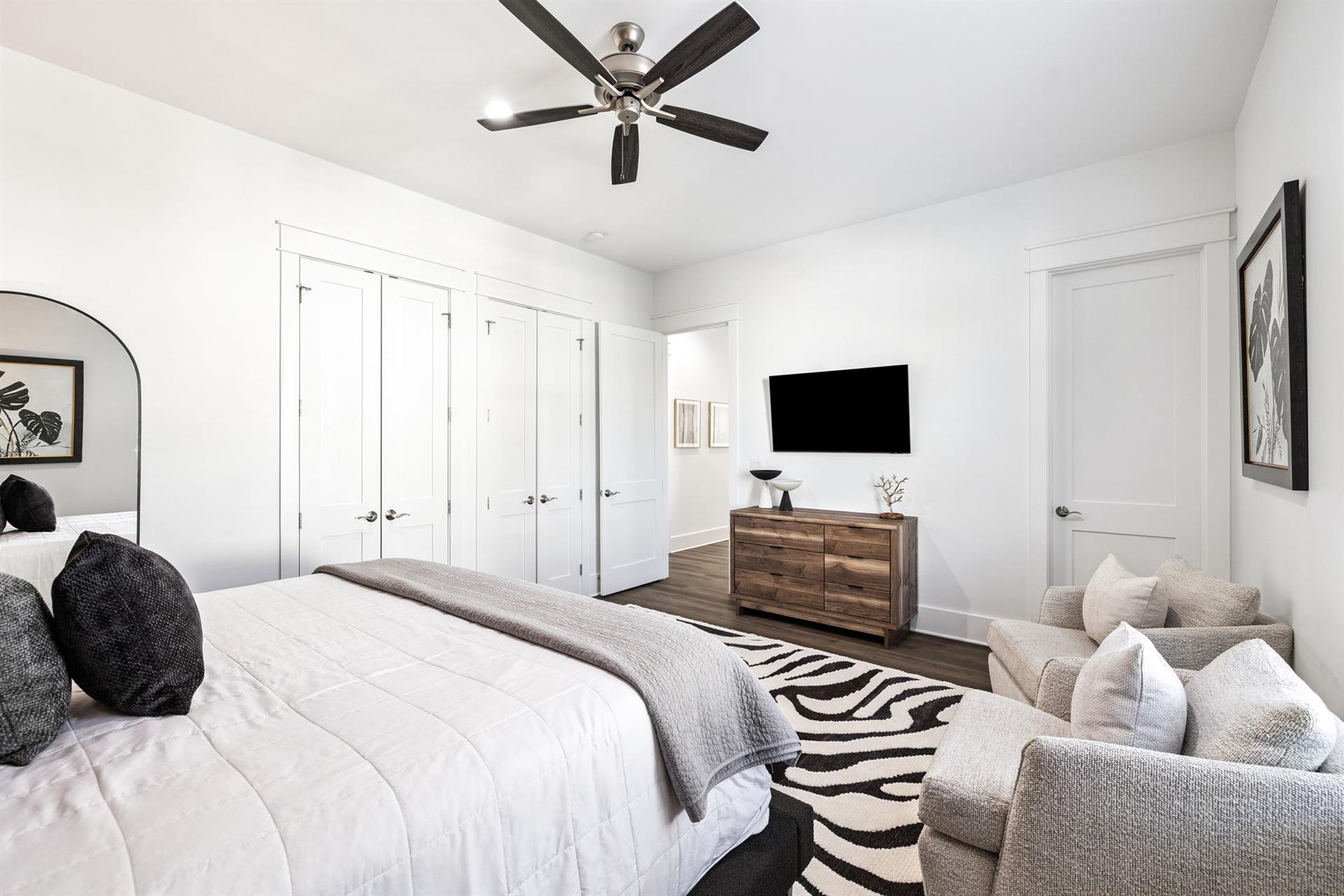 Your spacious bedroom features a plush bed, cozy seating area, and modern amenities for the perfect retreat.