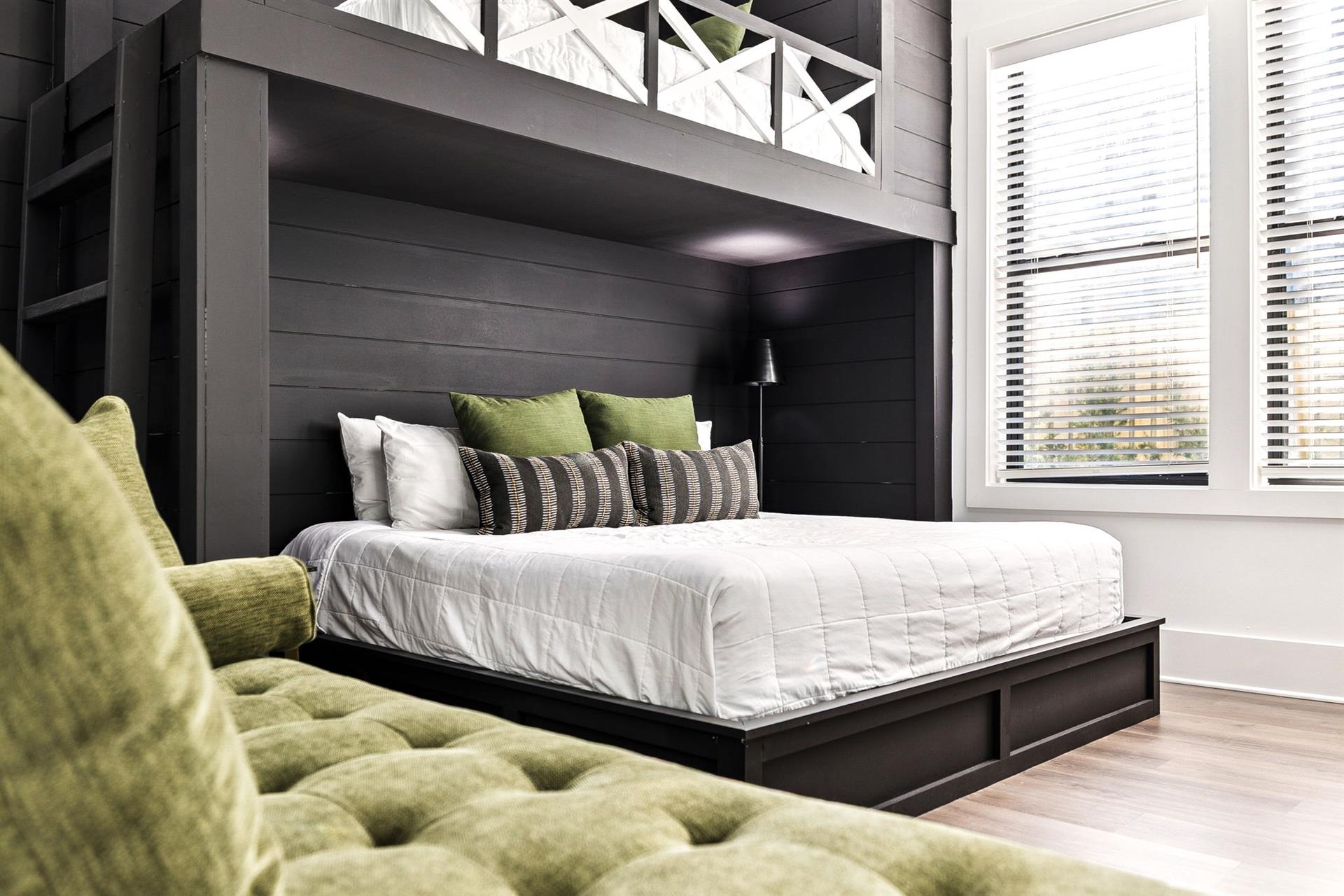 Your cozy bedroom retreat features a plush bed with crisp linens and vibrant green accents, perfect for peaceful rest.