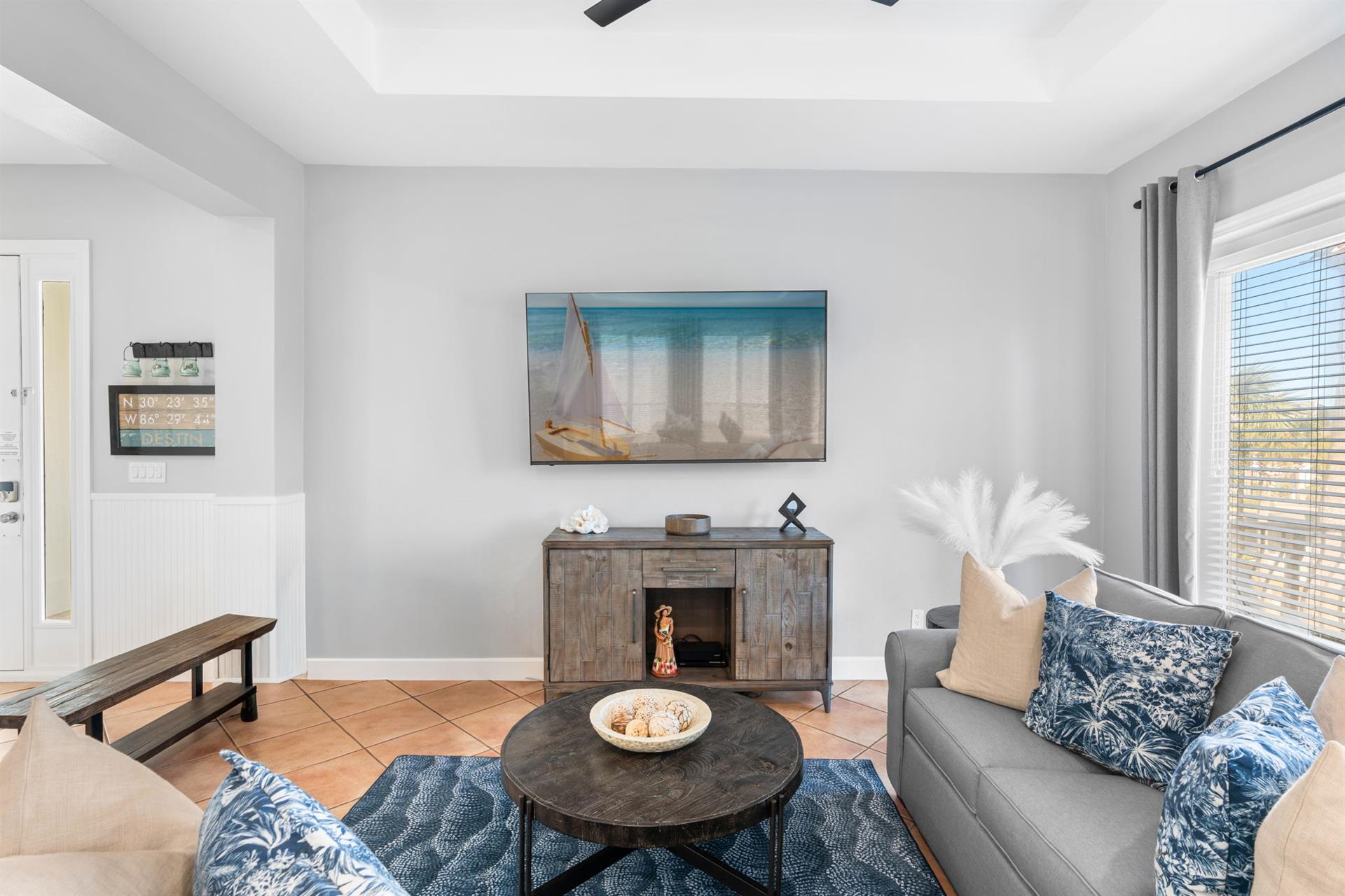 Unwind in your bright, coastalinspired living room featuring a cozy fireplace and comfortable seating for memorable evenings together.