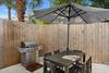 Relax under your private patio umbrella while savoring meals from your dedicated BBQ grill in this peaceful outdoor dining space.