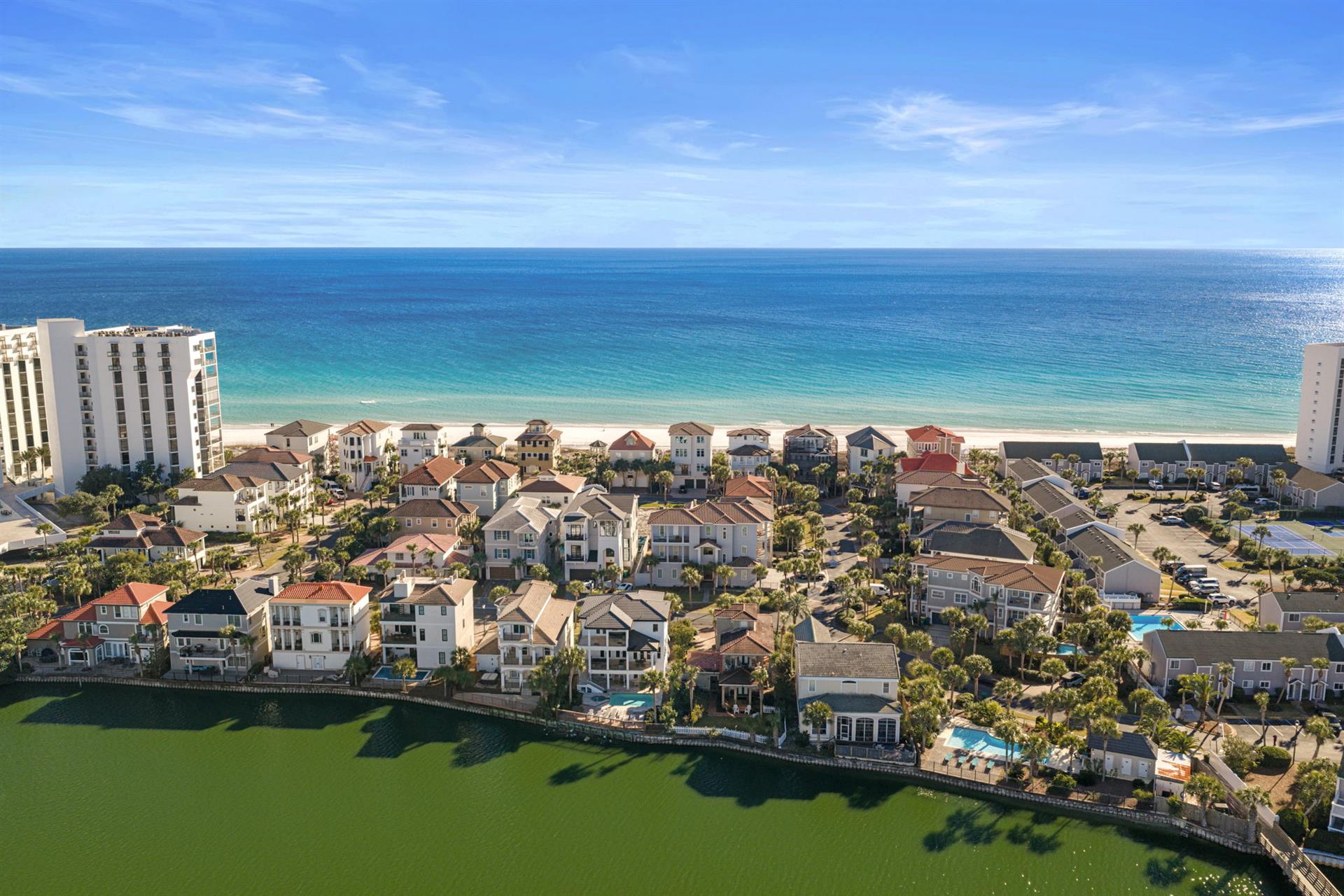 Stunning beachfront community featuring luxury homes along pristine white sand beaches and emerald waters.
