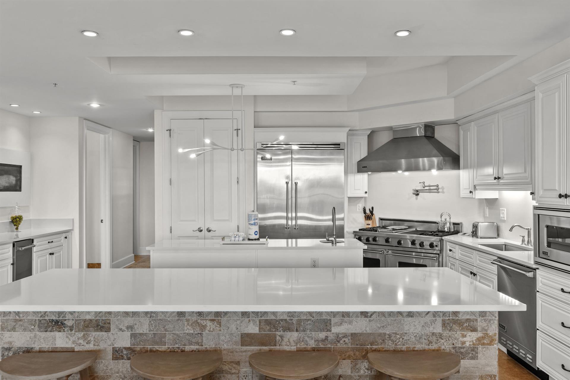 Prepare your favorite meals in this stunning chefs kitchen with premium appliances, spacious counters, and elegant white cabinetry that invites culinary creativity.