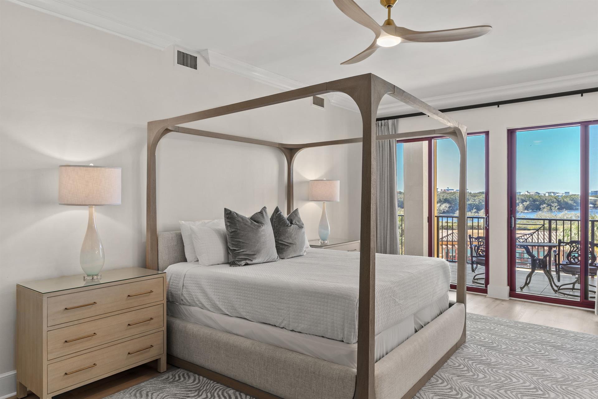 Wake up to stunning water views in your elegant canopy bed, where modern luxury meets peaceful mornings on your private balcony.