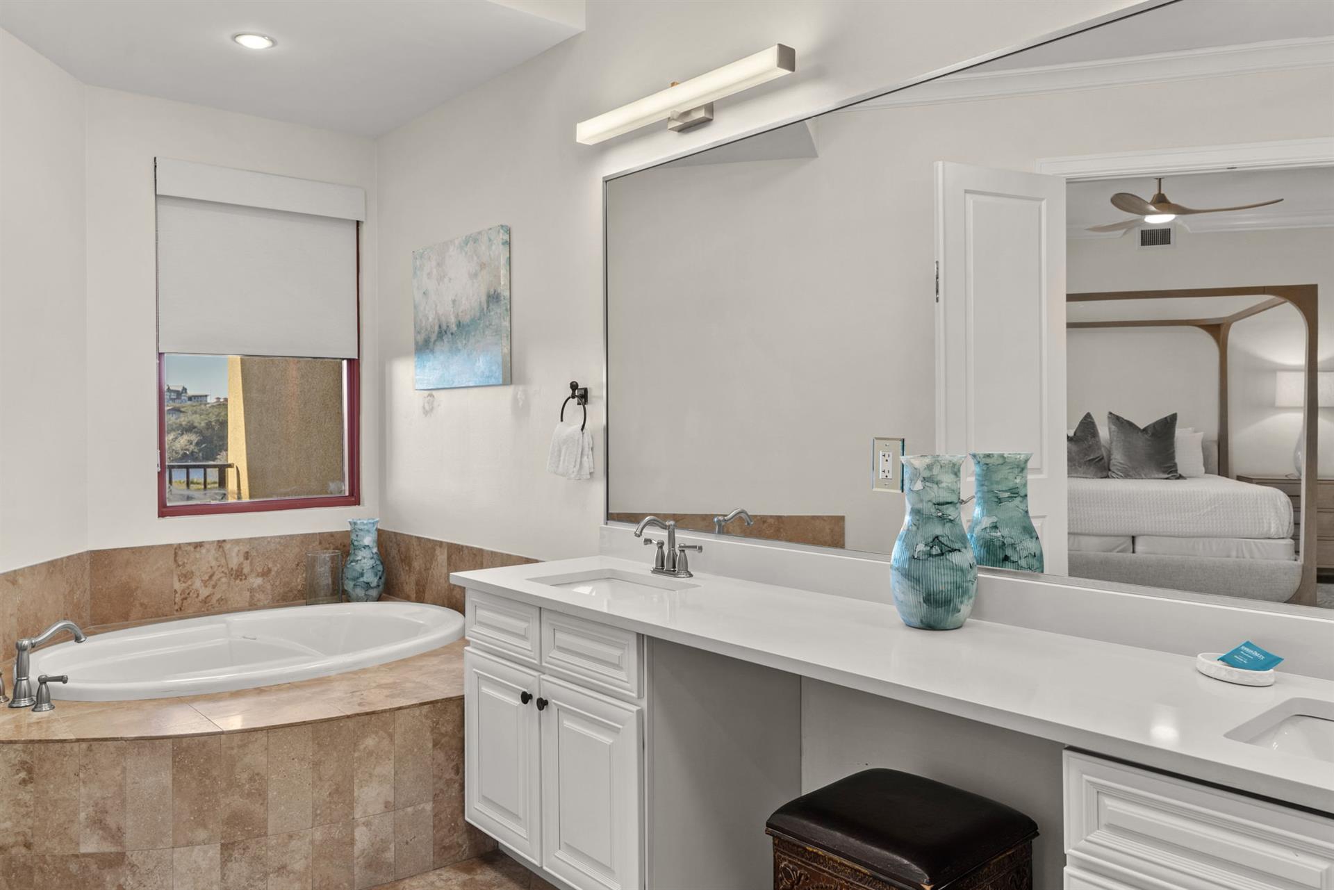 Unwind in your spacious bathroom featuring a luxurious soaking tub, dual vanities, and elegant touches that create your perfect retreat.