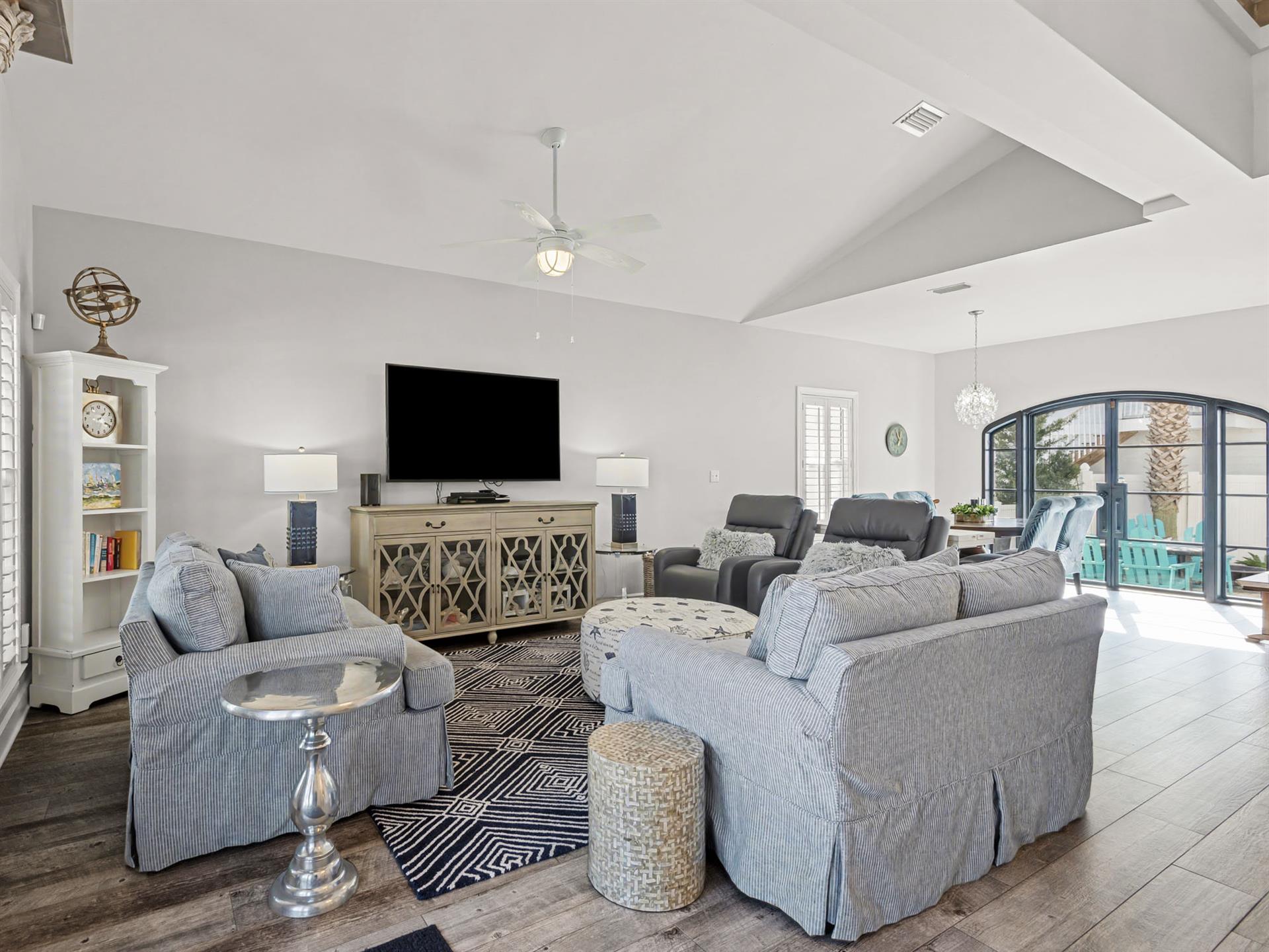 Sink into plush sofas in your spacious living room, where high ceilings and elegant decor create the perfect atmosphere for relaxation.