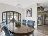 Youll love gathering around this elegant dining table beneath the sparkling chandelier, with natural light streaming through beautiful French doors.
