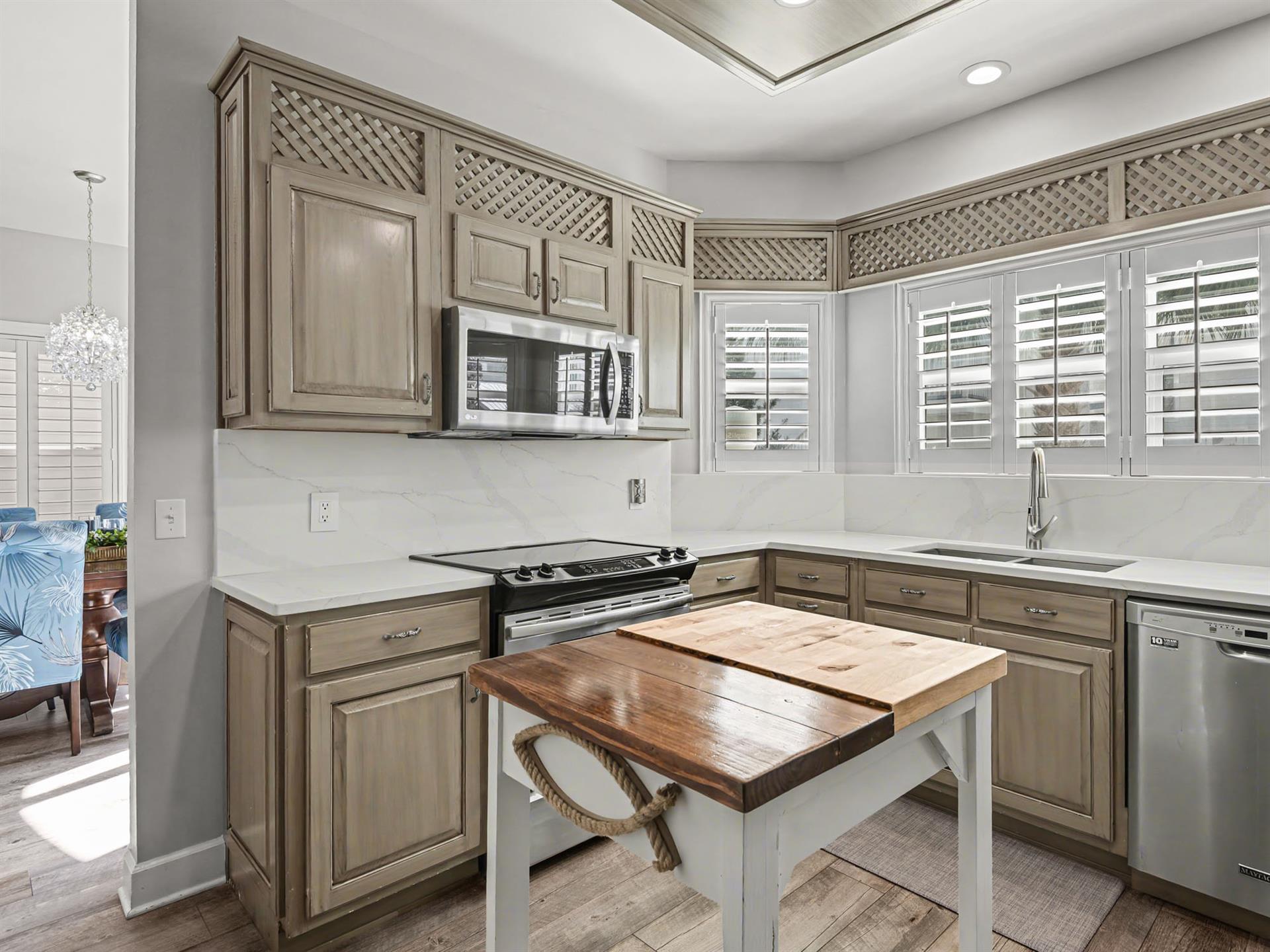 Your beautiful kitchen features elegant cabinetry, marble countertops, and modern appliances, perfect for preparing meals during your stay.