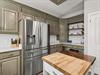 Prepare gourmet meals in your beautifully appointed kitchen featuring stainless steel appliances and elegant cabinetry.