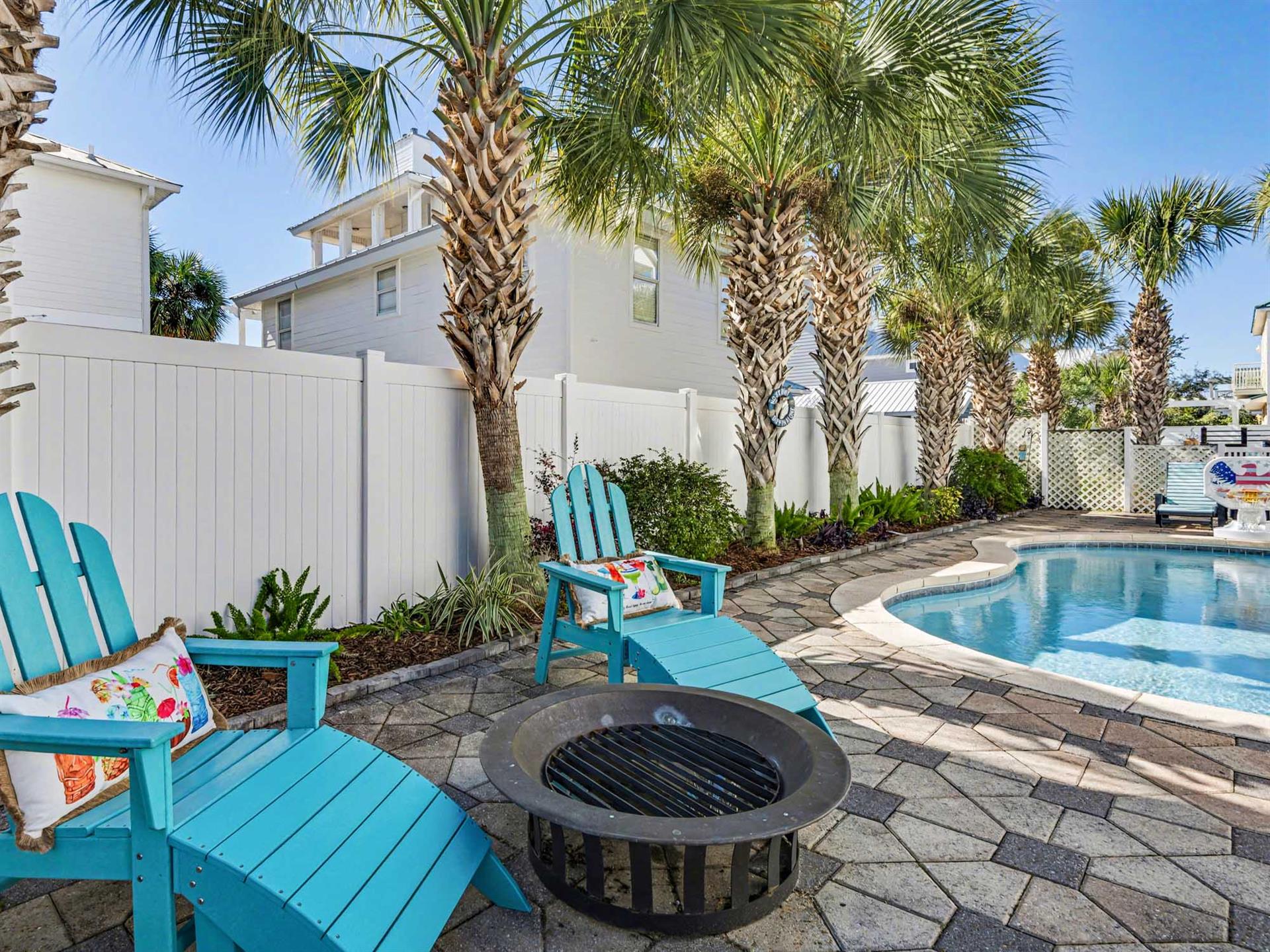 Your private pool oasis awaits with tropical palms and Adirondack chairs where youll unwind by the fire pit.