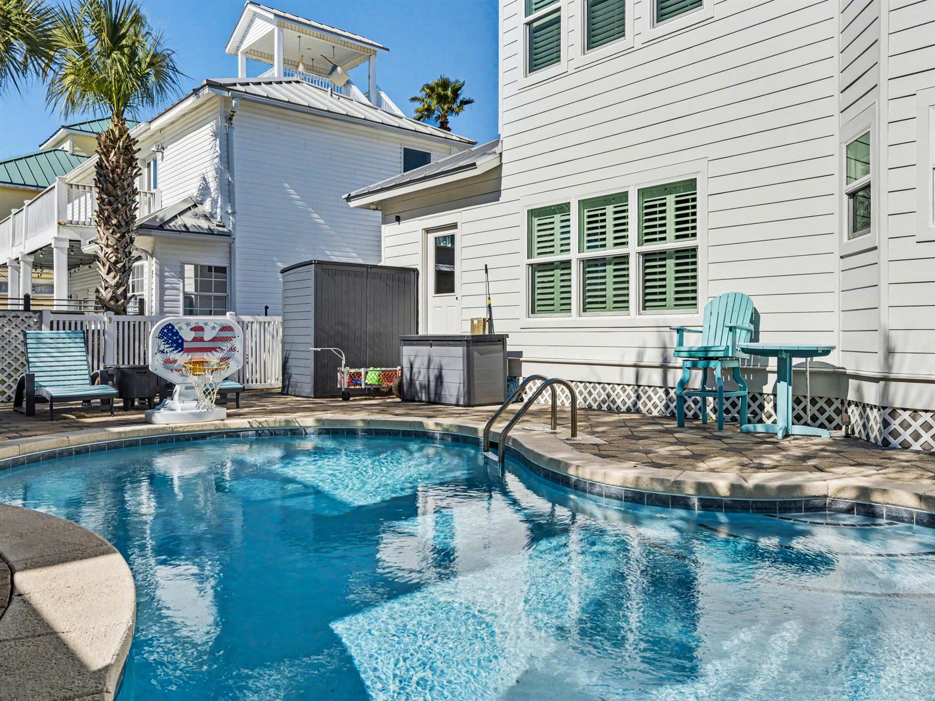 Your private pool awaits with crystalclear water and turquoise patio furniture for ultimate relaxation.
