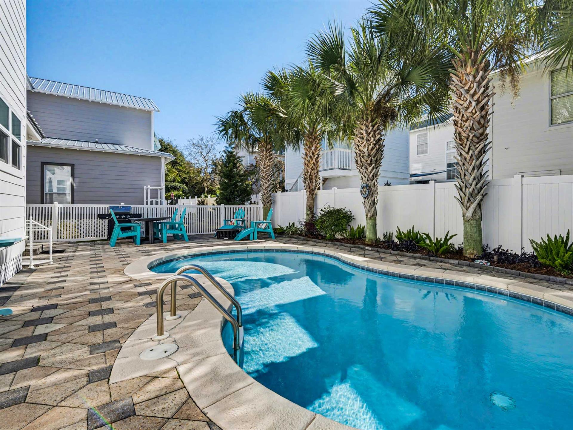Dive into your private oasis with this sparkling pool surrounded by swaying palms and turquoise loungers for perfect poolside relaxation.
