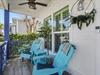 Unwind on your private covered porch with turquoise Adirondack chairs and soothing ceiling fan breeze.