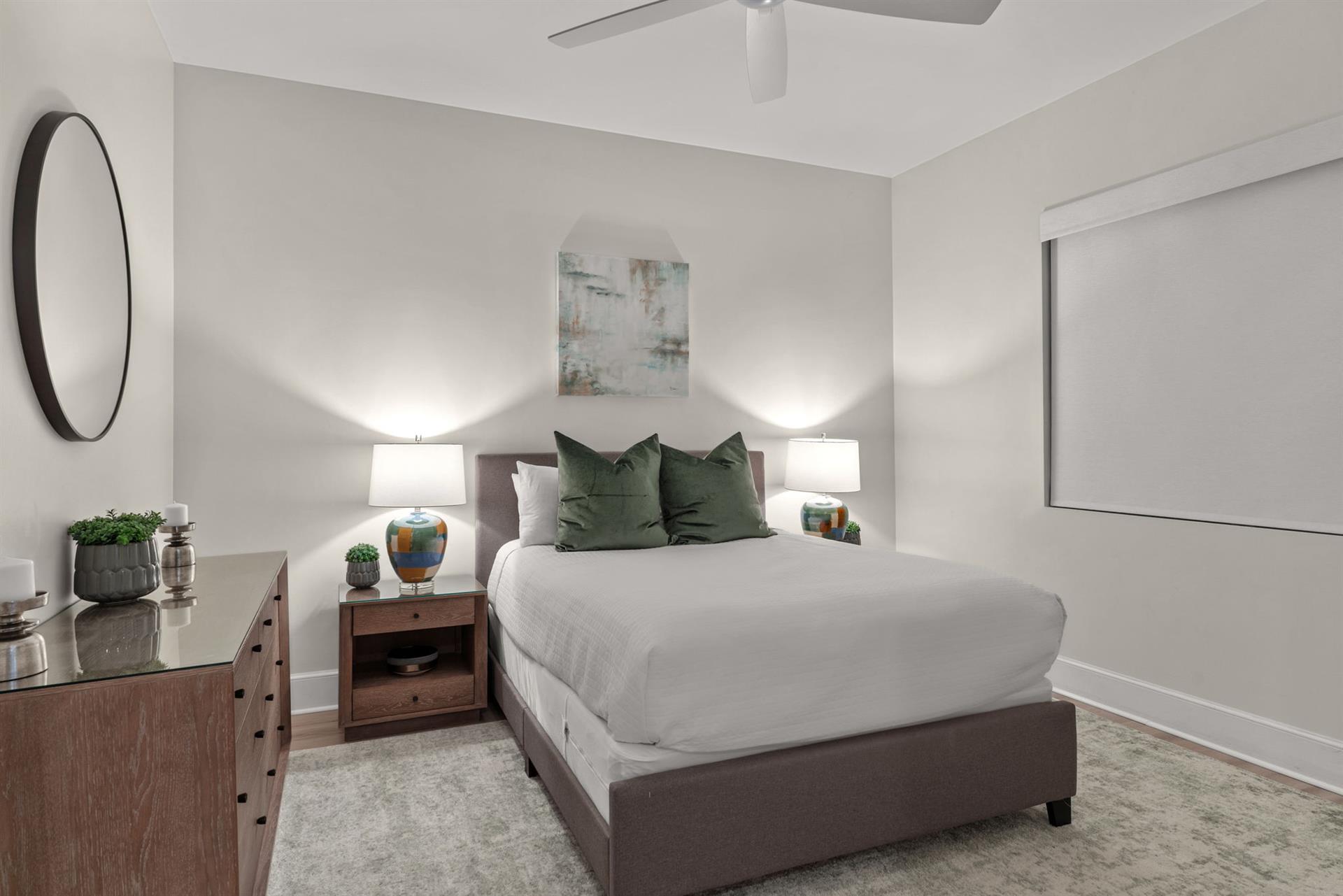 Sink into this serene bedroom where soft linens and gentle lighting create your perfect retreat after exploring.