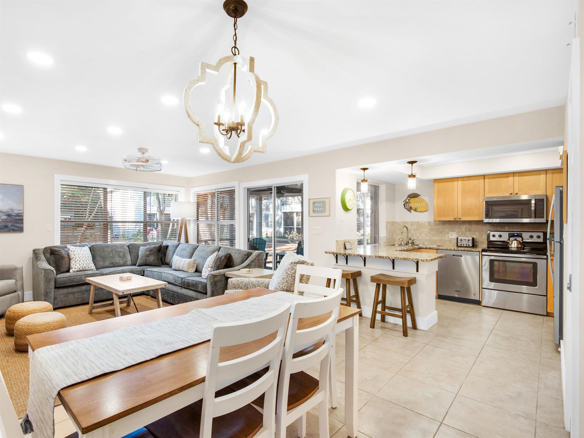 Openconcept retreat with modern kitchen, comfortable sectional, and dining for six