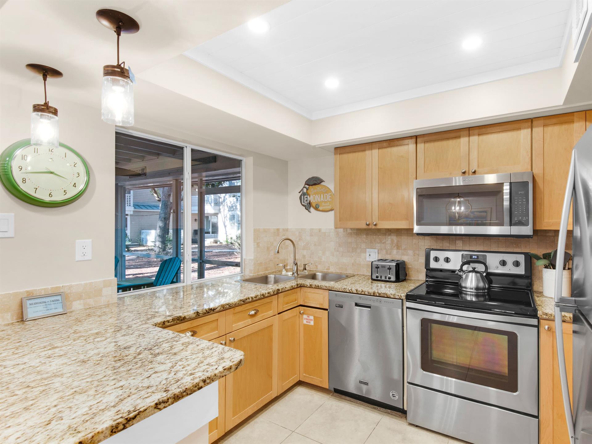 Morning sunlight streams into kitchen with pass through window to patio.