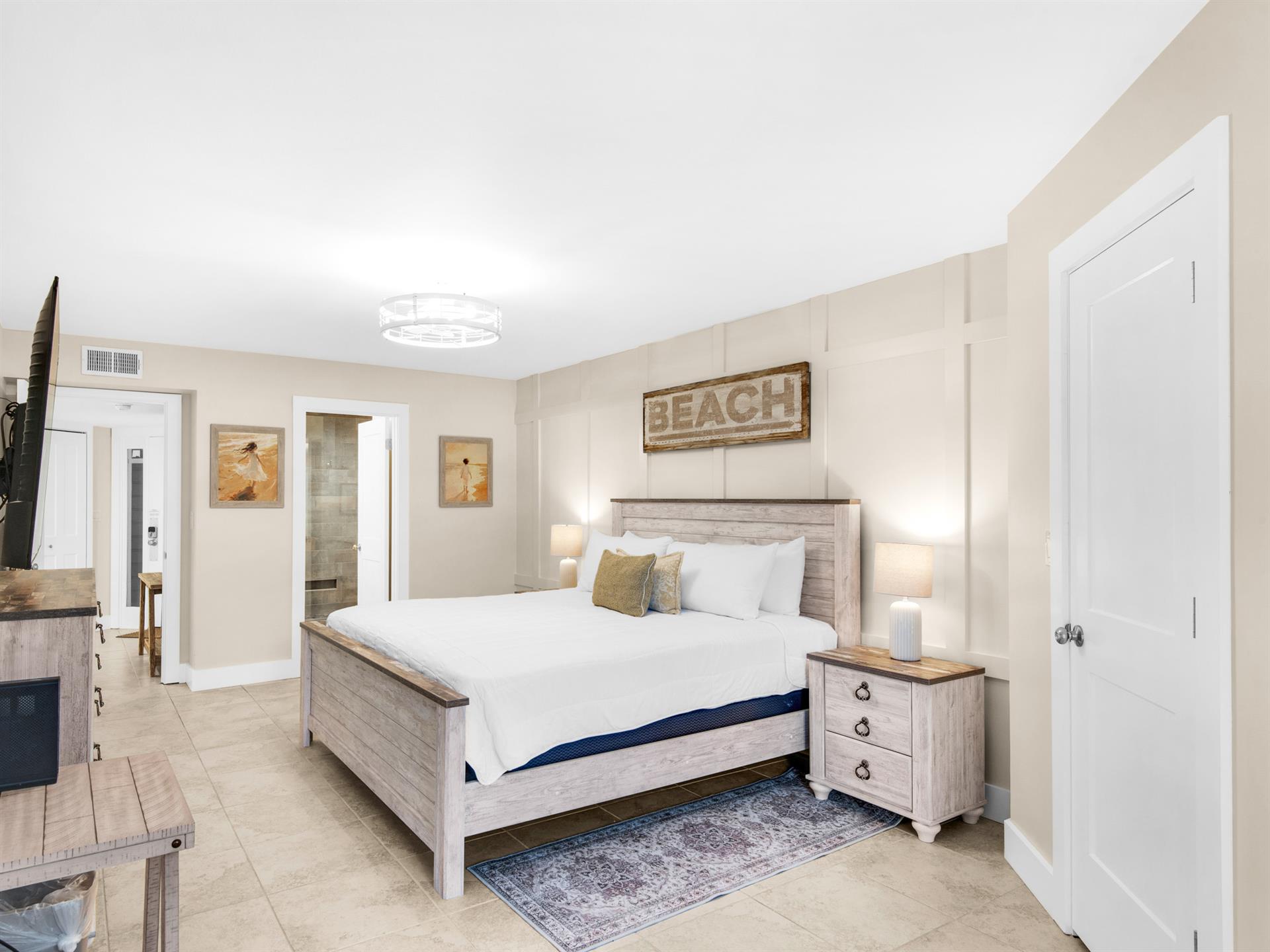 Step into your coastalthemed bedroom where weathered wood and beach artwork create a serene seaside retreat for peaceful nights.