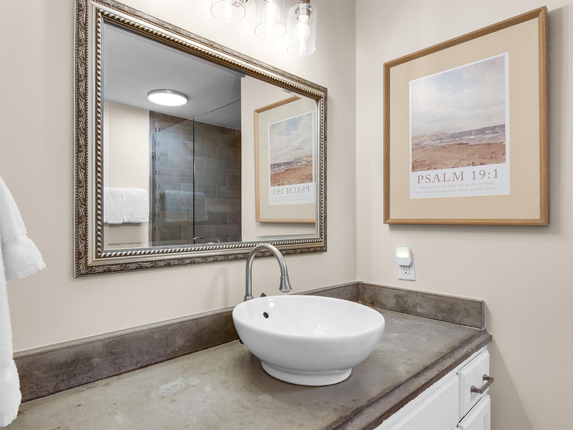Elegant bathroom with vessel sink and stylish decor awaits your morning routine.