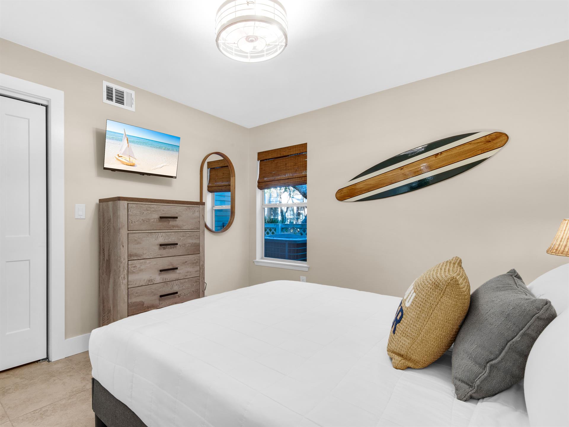 Drift off peacefully in your coastalthemed bedroom, complete with beach artwork and surfboard decor creating perfect vacation vibes.